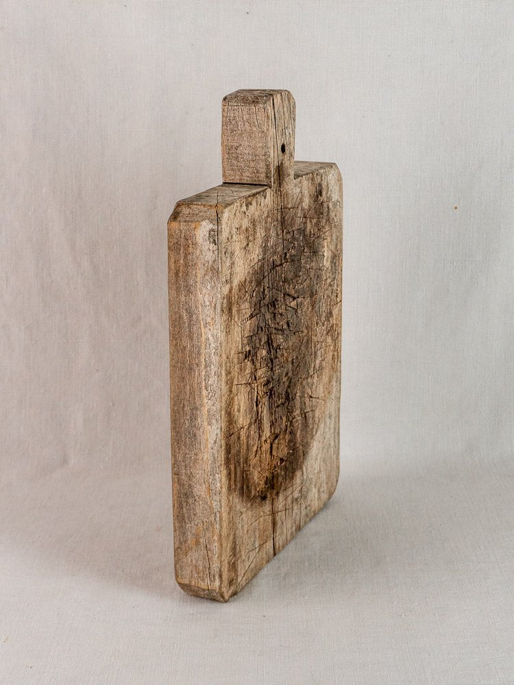 Late 19th century French antique bread board in solid wood with rustic patina and wear.