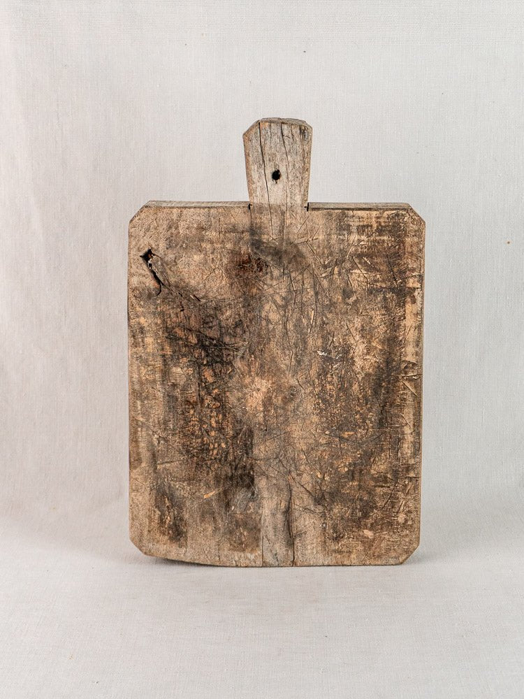 Antique French bread board, late 19th century solid wood with handle, aged patina and wear.