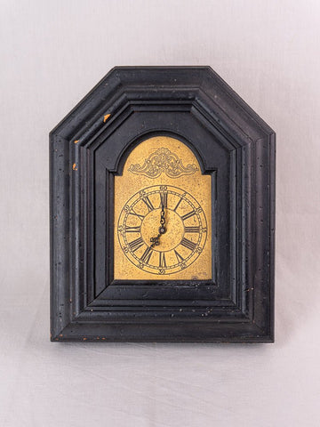 Antique French black wood wall clock with gold face, ornate detail, circa late 19th century.