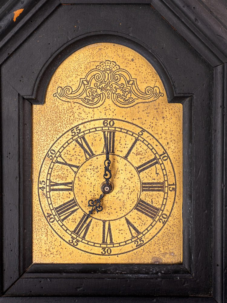 Antique French wall clock, late 19th-century, black painted wood, gold face, Roman numerals.