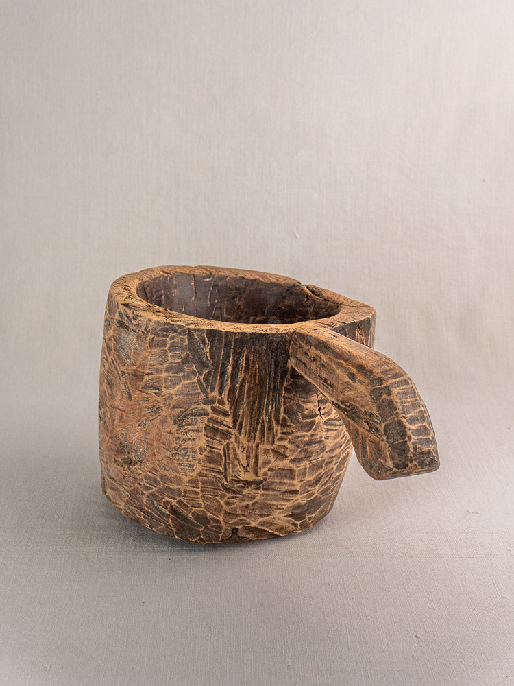 Antique French wooden mortar and pestle, hand-carved with tool marks and rustic texture.