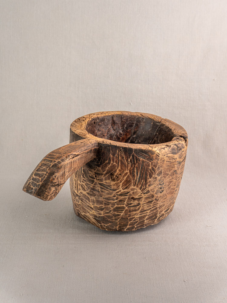 Antique French wooden mortar, late 18th–early 19th century, hand-carved, on gray background.