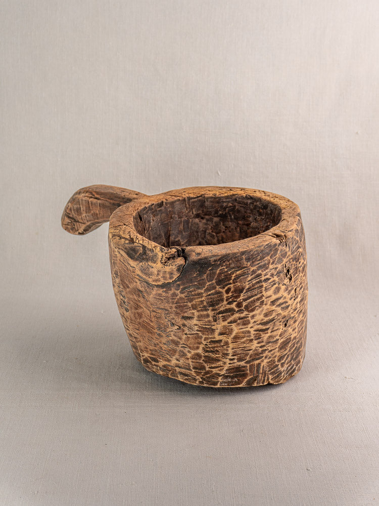 Antique French wooden mortar, late 18th to early 19th century, hand-carved rustic style on gray background.