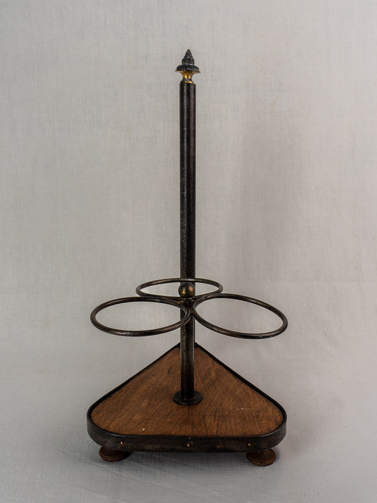 Antique French wrought iron and wood bottle carrier with three holders and ornate finial.