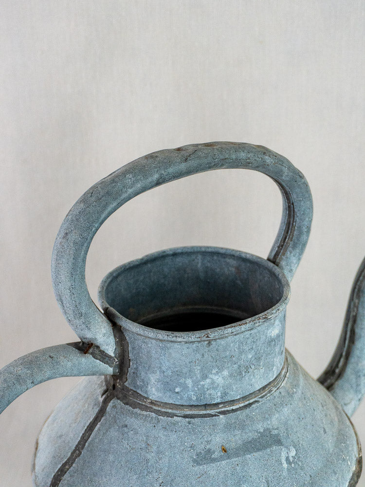 French antique zinc Broc à Eau water pitcher with curved handle, aged blue-gray patina, and natural rust.