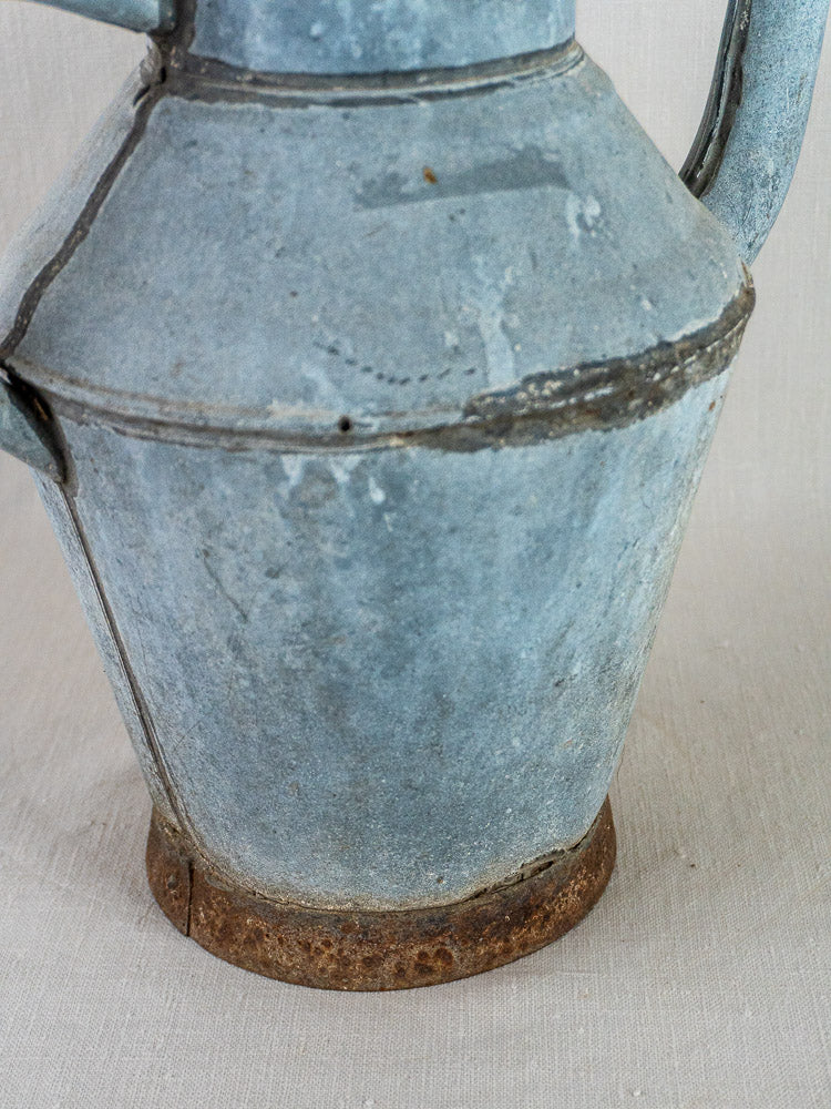 French zinc Broc à Eau vintage water pitcher with blue-gray patina and rusted, textured base.