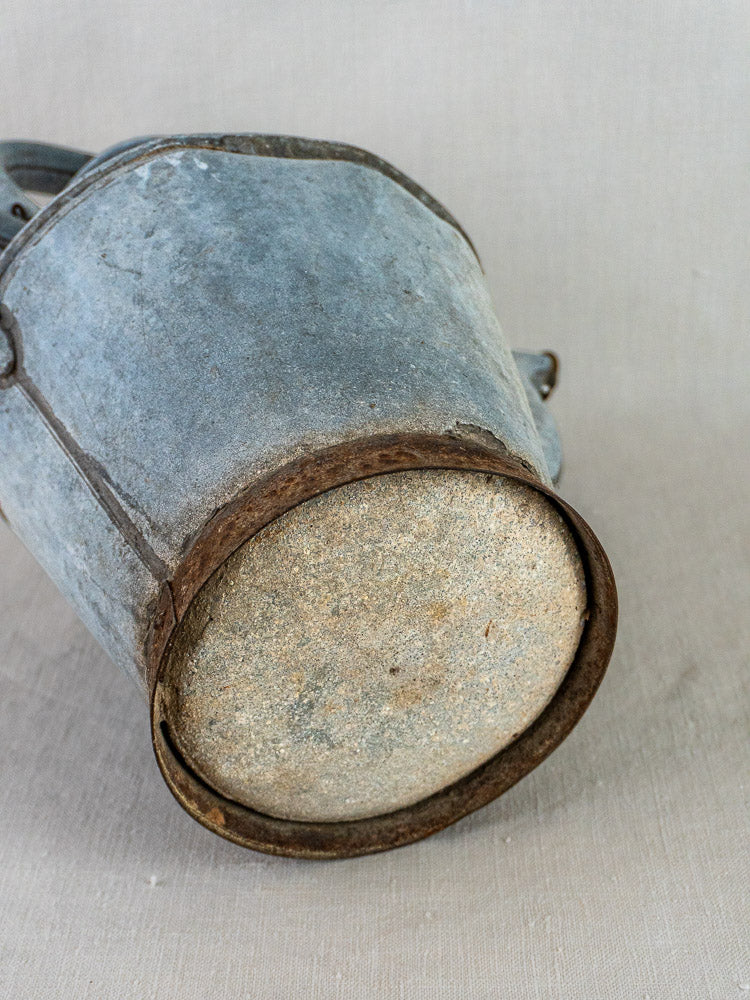 French zinc broc à eau antique water pitcher, blue-gray patina, rusted edges, beige underside.