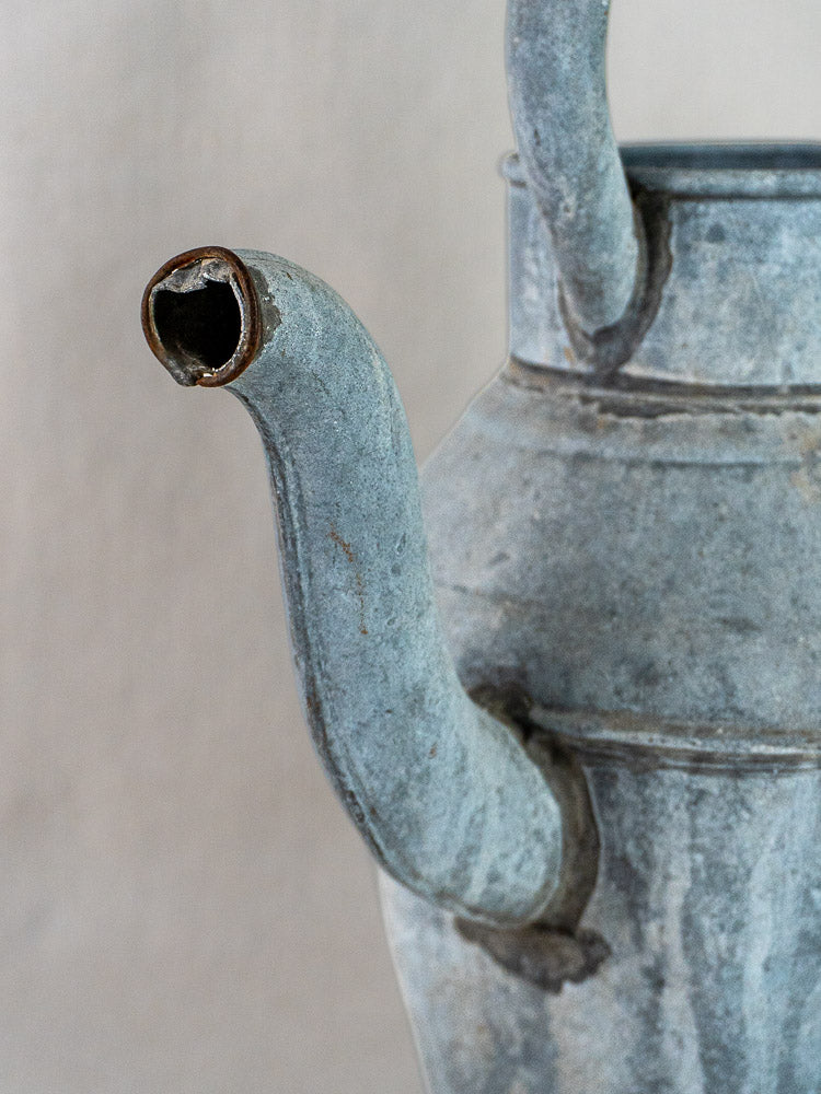 Antique French zinc broc à eau water pitcher with blue-gray patina and curved handle.