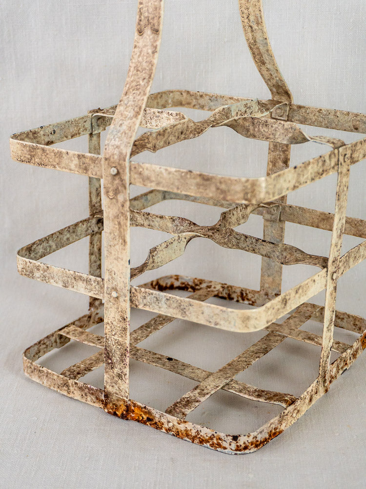 Antique French painted zinc four-bottle wine carrier with grid structure and weathered finish.