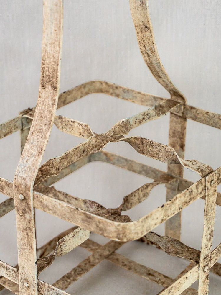 Painted zinc French antique wine carrier with rustic grid design and weathered, peeling finish.