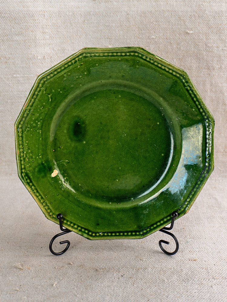 Pair of antique French green glazed plates from Drôme, late 19th–early 20th c., on black metal stand.