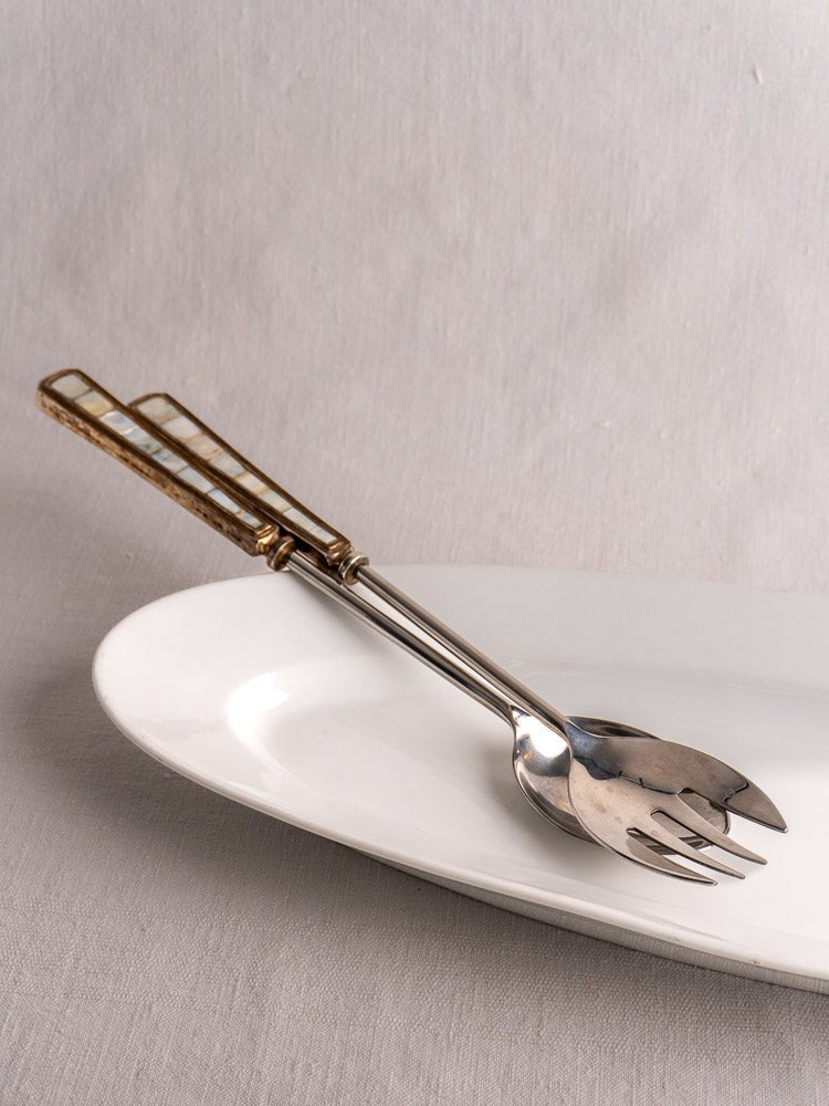 19th-century French white ironstone turbot platter with metal serving set on light background.