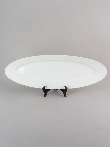 19th-century antique French white ironstone turbot platter displayed on a black stand, gray background.