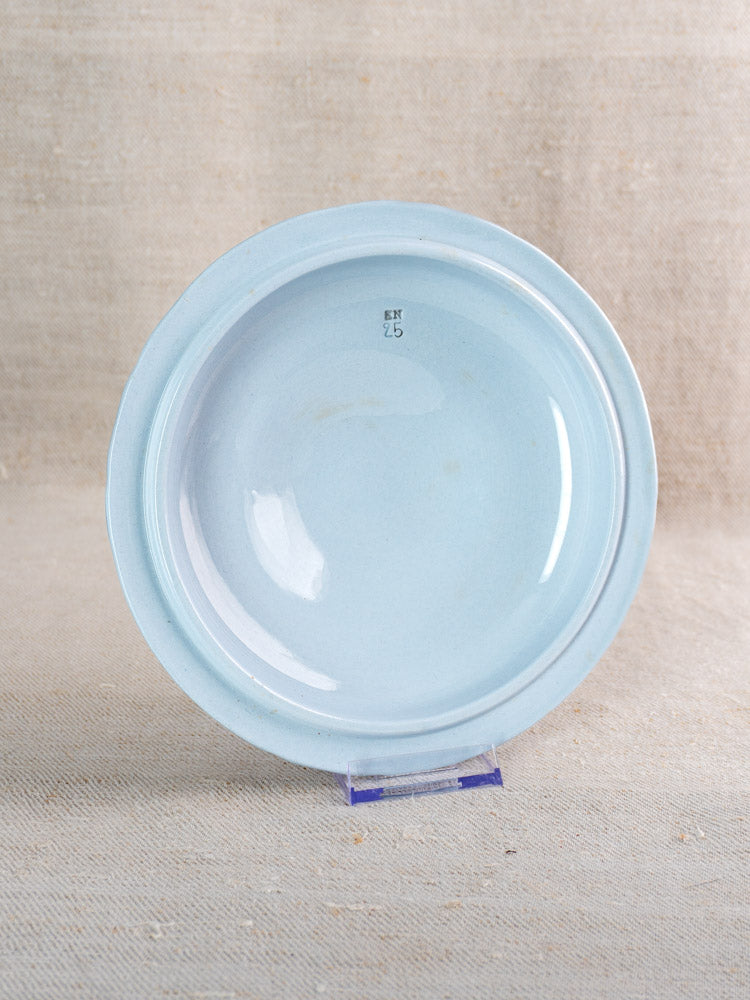 Antique Villeroy & Boch Mettlach tureen with soft blue glaze, upside down on beige fabric.