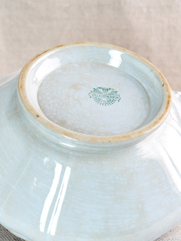 Antique Villeroy & Boch Mettlach tureen base with soft blue glaze, green logo, crackle texture, on neutral fabric.
