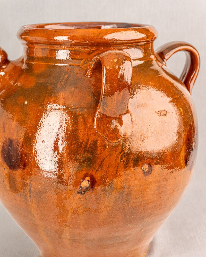 Antique French Provencal oil jar, 19th-century glazed terracotta with two handles and rounded body.