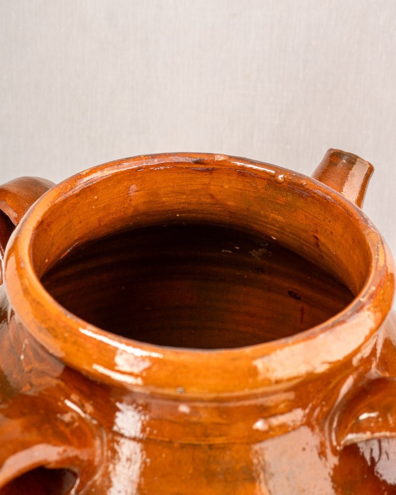 Antique French Provençal oil jar, 19th-century glazed terracotta with two handles and spout.