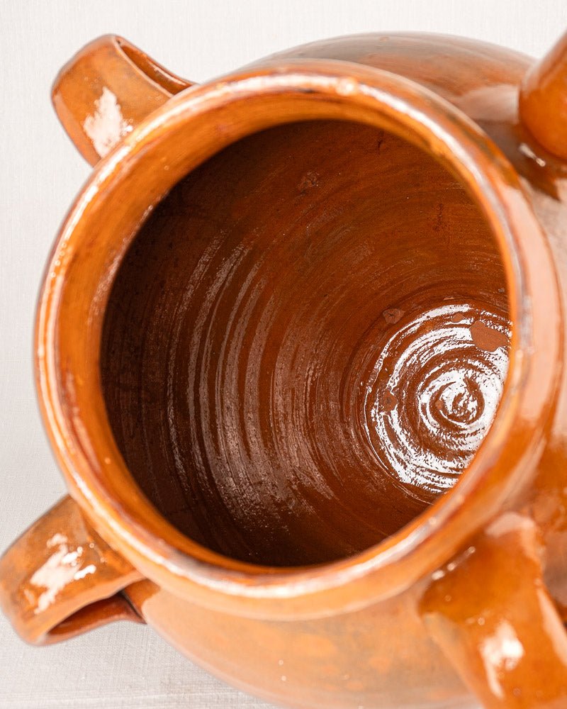 19th-century French terracotta oil jar, glossy brown glaze, top view with two handles.