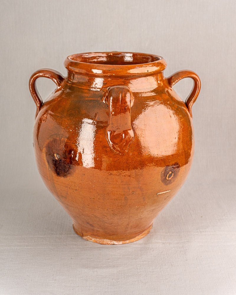 19th-century French glazed terracotta oil jar with brown finish, side handles, and spout detail.
