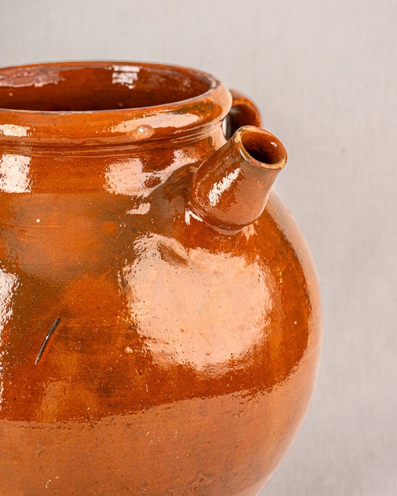 Antique French oil jar, 19th-century brown glazed terracotta with spout and handle, Provencal style, on light gray background.