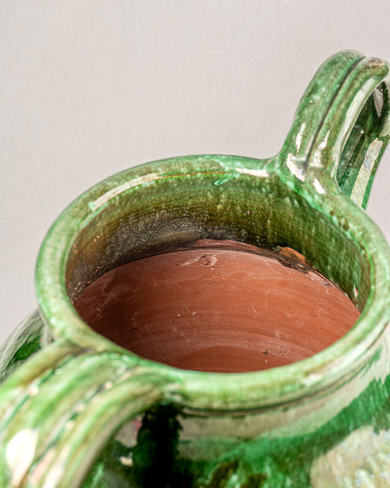 19th-century French green glazed earthenware cruche with two handles and unglazed reddish-brown interior.