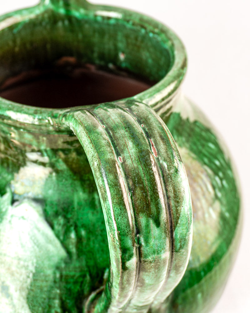 Antique French cruche, 19th-century green glazed earthenware jug with ribbed handle and glossy finish.