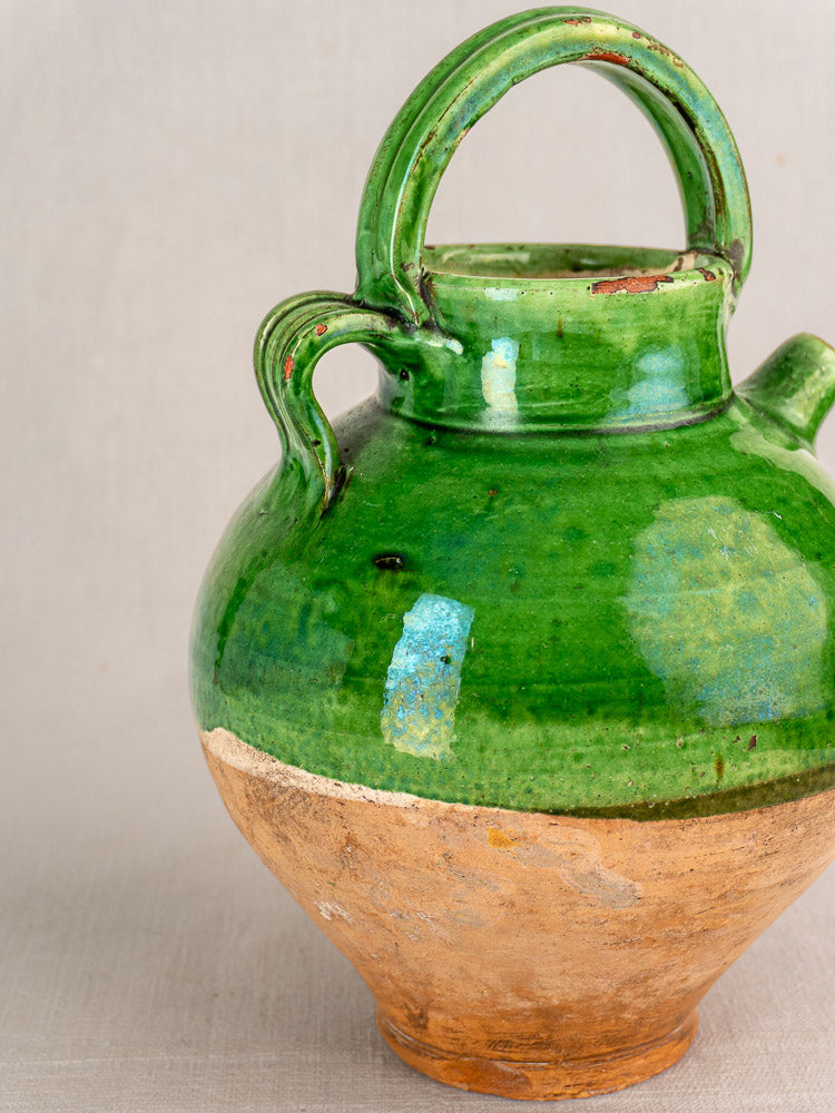 Antique French green glazed terracotta gargoulette with dual handles and textured clay lower half, Provençal pottery style.