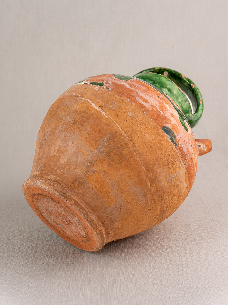 Antique French green-glazed earthenware gargoulette with unglazed rounded body and aged patina, late 19th–early 20th century.