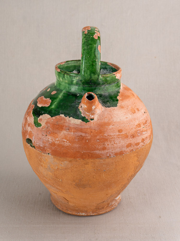 Antique French green glazed earthenware gargoulette water jug with handle and spout; rustic terra cotta patina.