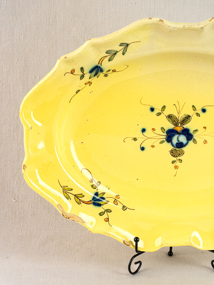 Antique French faience platter, c. 1880–1900, yellow glaze, scalloped edge, blue-green floral designs on stand.