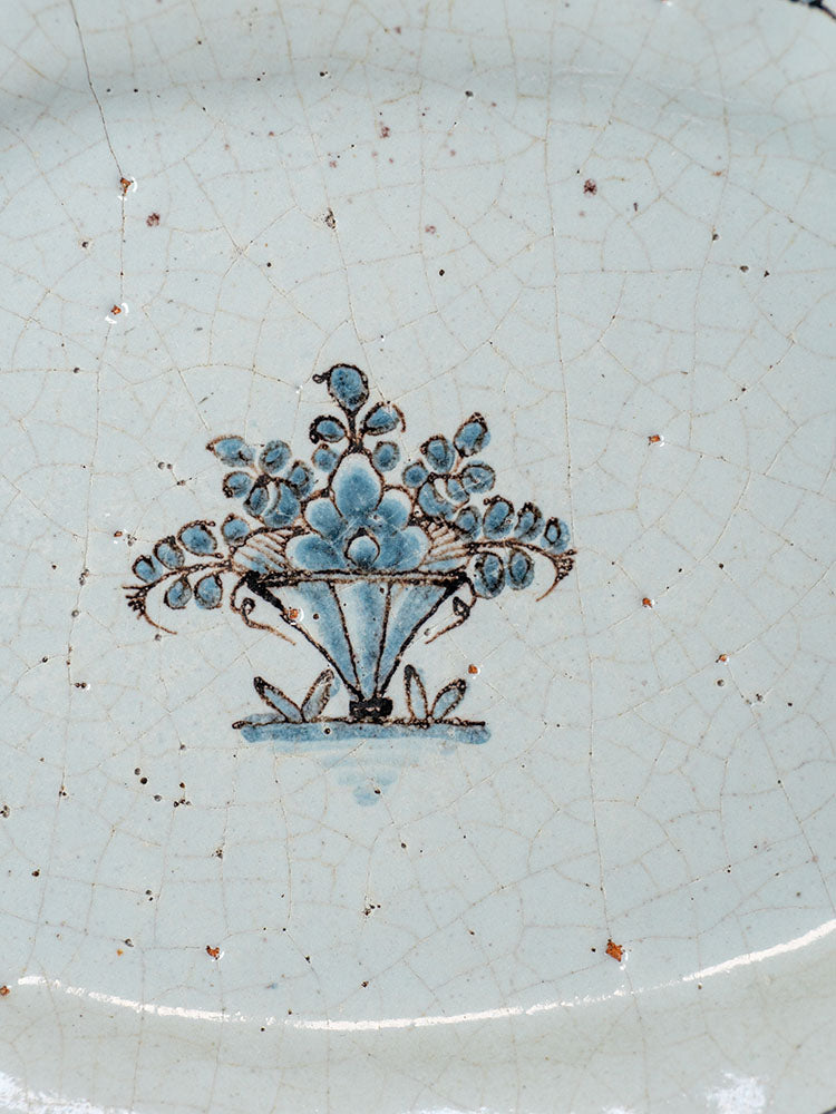 18th-century French faience platter, Cul Noir style, crackled glaze with blue fruit and flower basket motif, surface cracks visible.