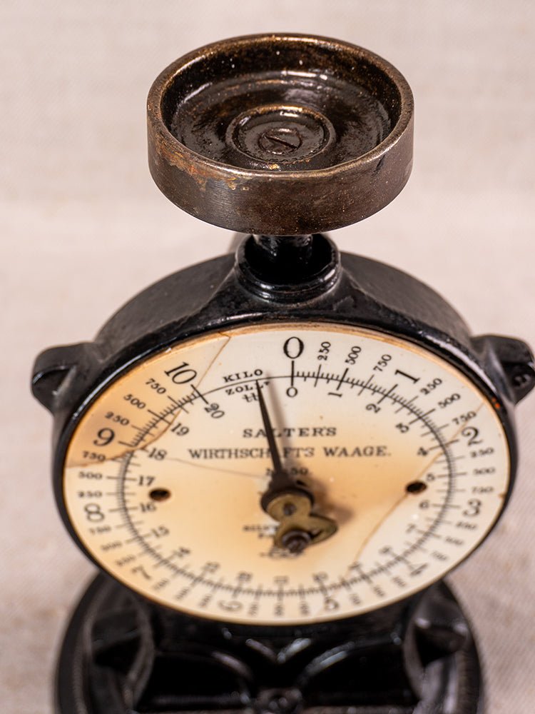 Antique Salter Kitchen Scale No. 50 in black cast iron with round metric dial and weighing platform.