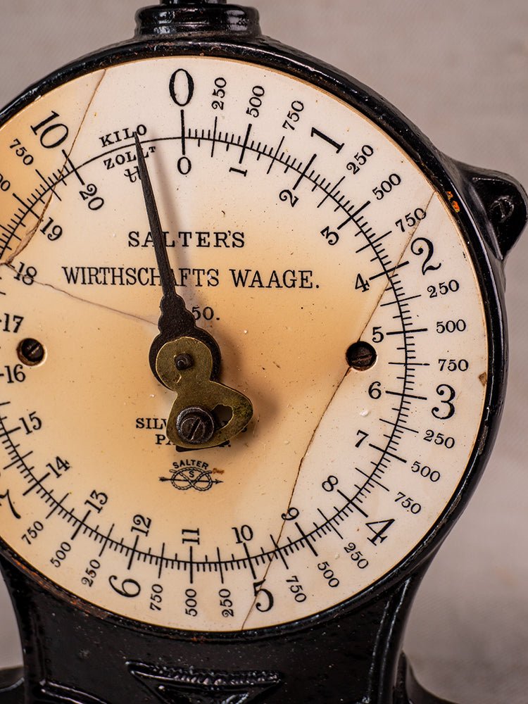 Antique Salter No. 50 cast iron kitchen scale with brass needle on aged white dial, visible cracks.