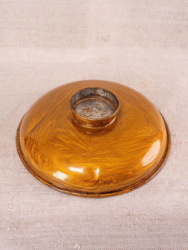 Round golden-brown metal detail from Antique Salter Kitchen Scale on beige textured fabric background.