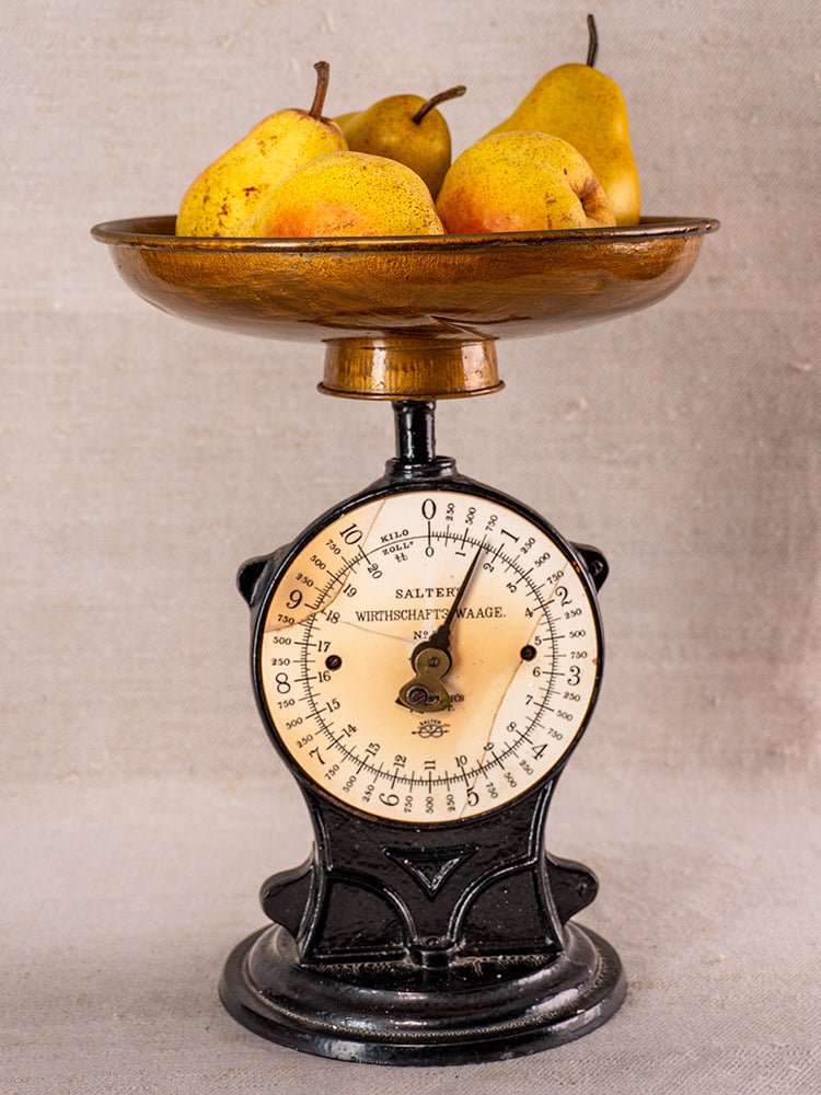 Antique Salter Wirthschafts Waage No. 50 cast iron kitchen scale with four yellow pears on neutral fabric.