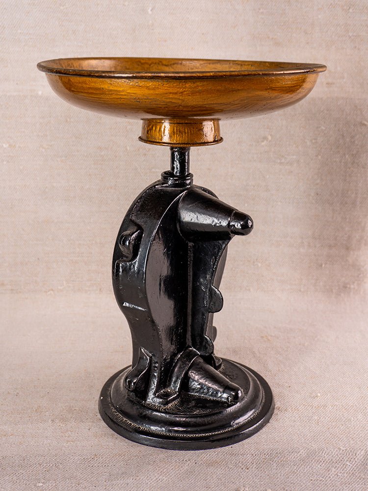 Decorative dish with wooden bowl on black cast iron base featuring two sculpted dolphins.