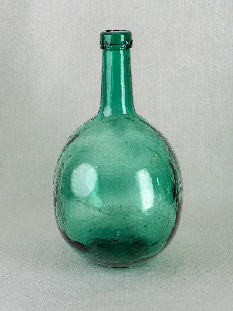 Set of three hand-blown Spanish green glass demijohns with round bodies and short necks.
