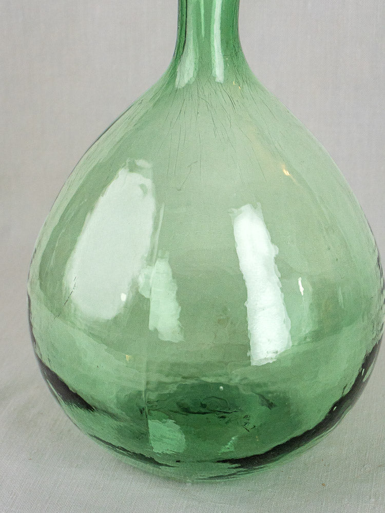 Hand-blown Spanish green glass demijohn base with rounded form, reflections, and subtle wear.