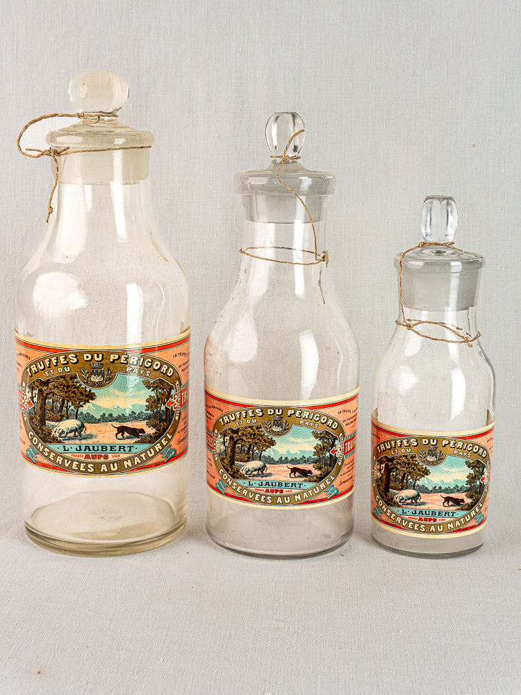 Set of three antique French L. Jaubert glass truffle jars with vintage labels, circa 1900.