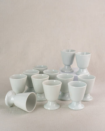 Set of twelve vintage French porcelain mazagran coffee cups by CNP Tradition France, one lying on side.