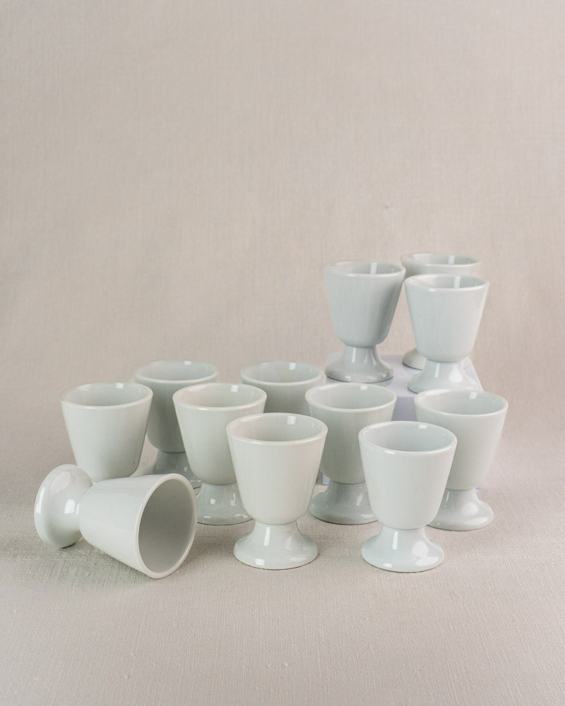 Set of 12 vintage French porcelain Mazagran coffee cups by CNP Tradition France, one on its side.