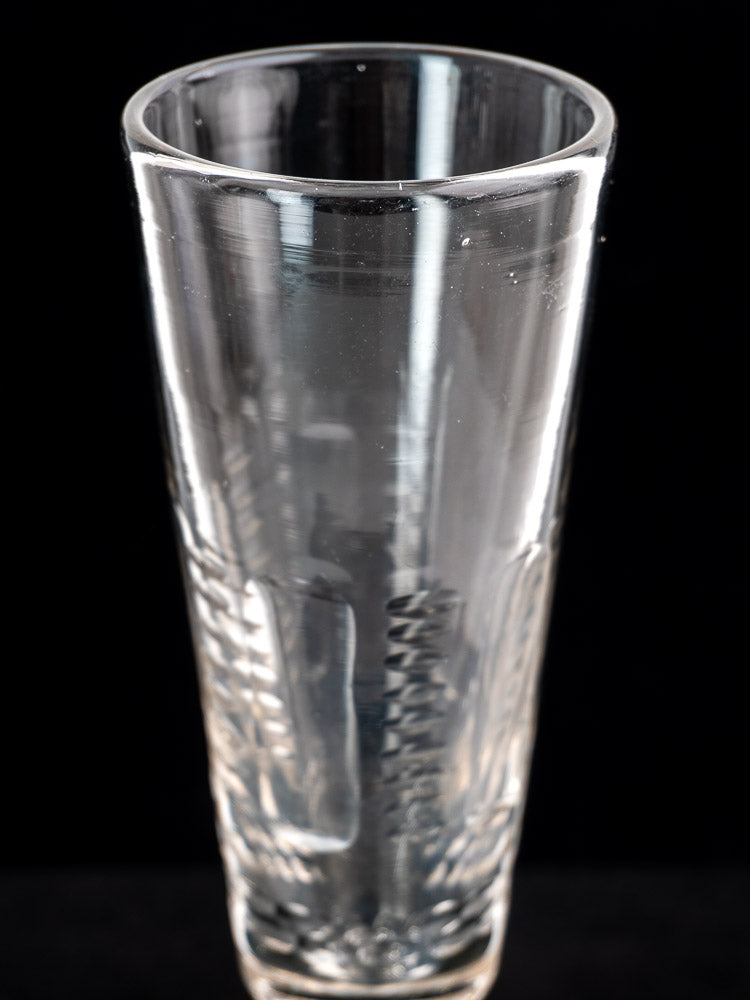 Set of six antique French uranium glass beer flutes, c.1900, with textured pattern on black background.