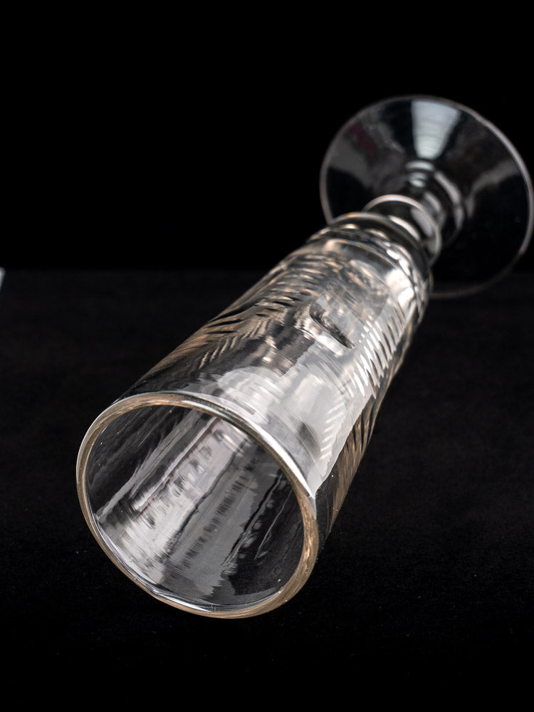 Antique French uranium glass beer flute, circa 1900, with textured Belle Epoque design on a black surface.