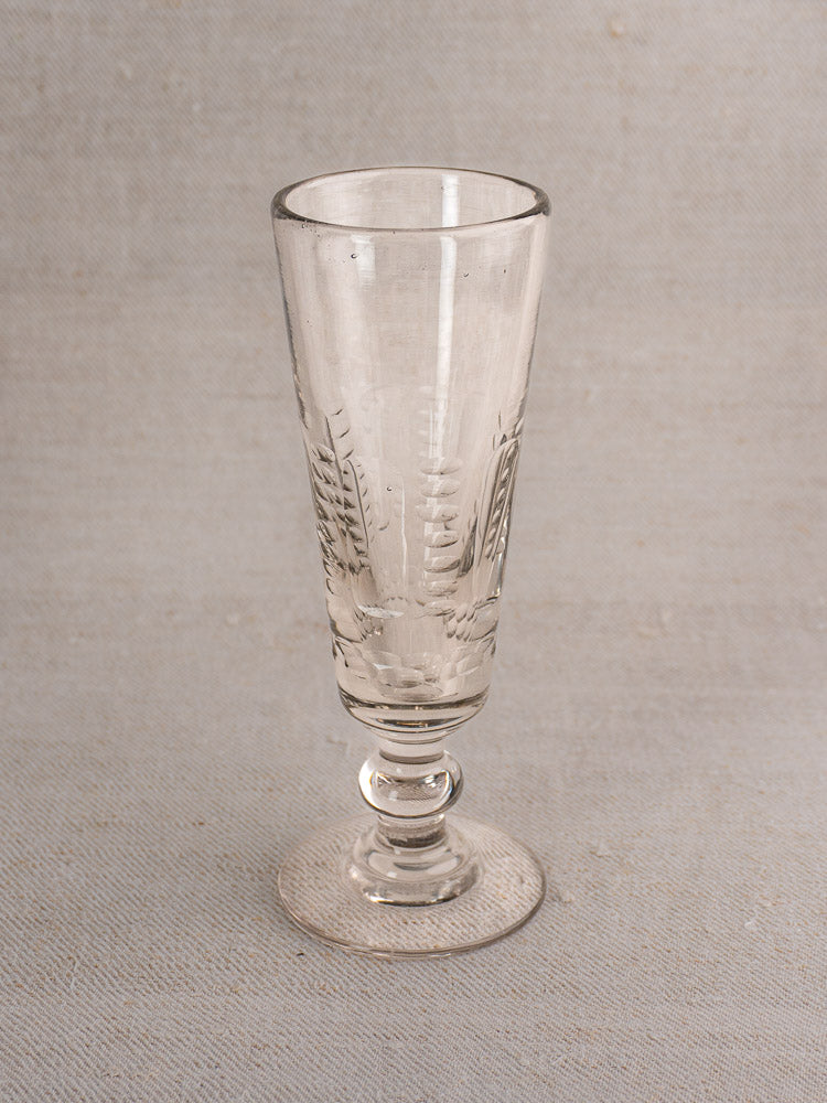 Set of 6 antique French uranium glass beer flutes with tall fluted bowls, Belle Epoque style, on a neutral surface.