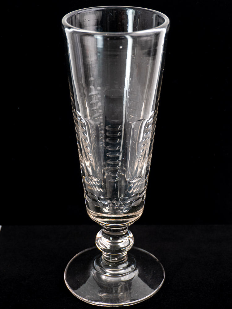 Set of six antique French uranium glass beer flutes with Belle Epoque etched patterns on round bases, black background.