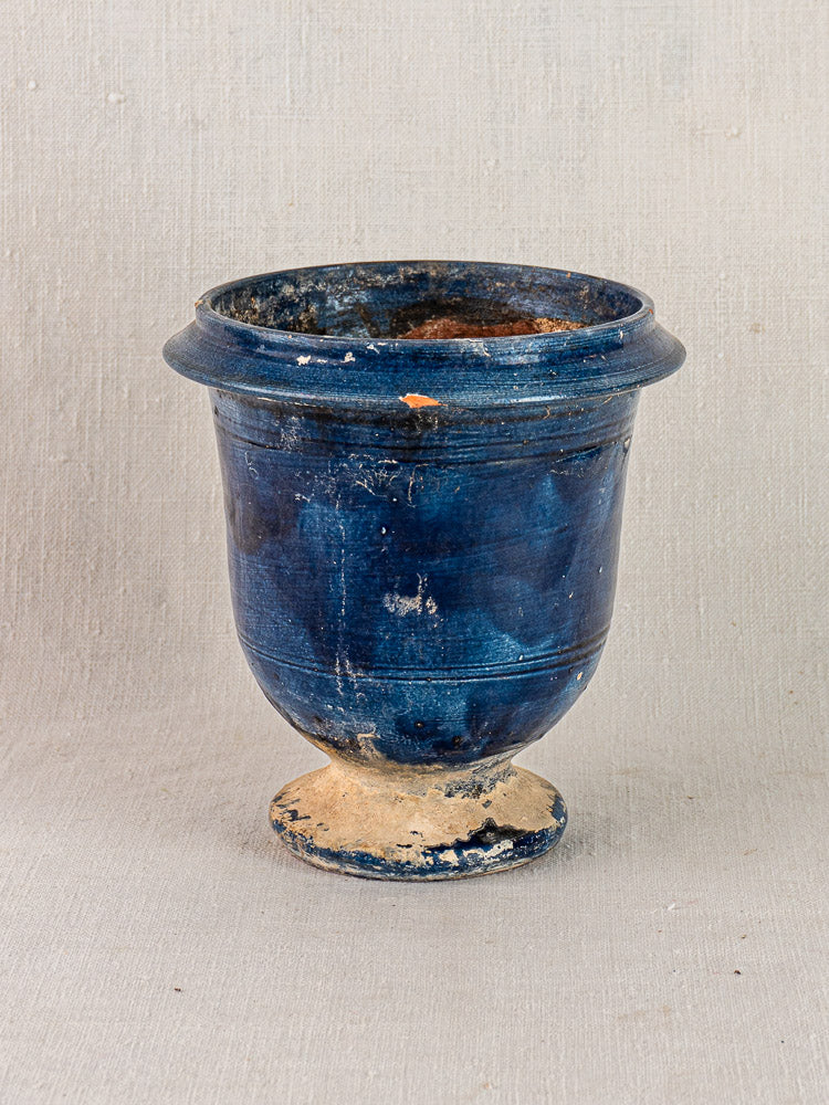 Antique French Medici vase, blue glazed terracotta with wide rim, weathered and lightly chipped on textured surface.