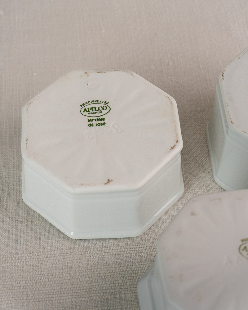 White octagonal Apilco Limoges porcelain pot upside down, maker’s mark visible, two matching pots beside.