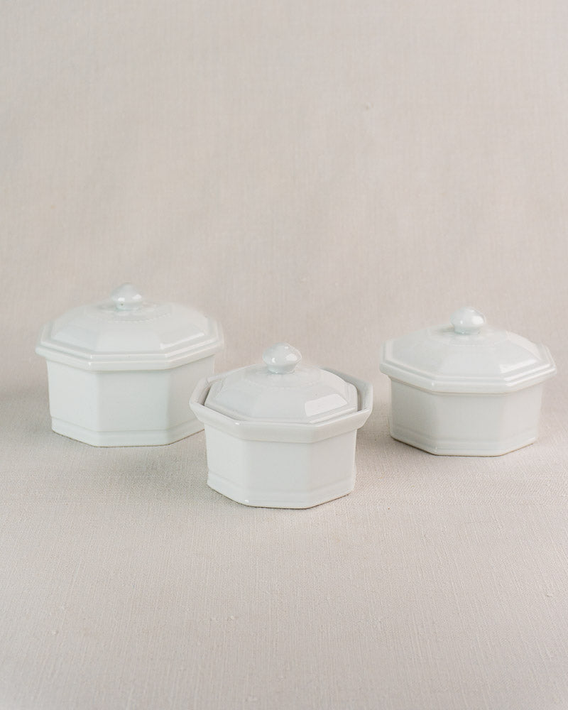 Set of three vintage French Apilco porcelain pots, octagonal with lids, one with side handles.