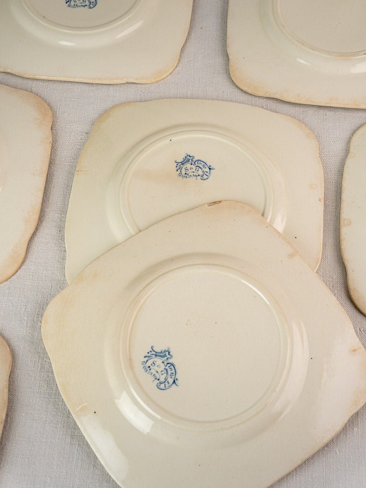 Antique French Clairefontaine Faience Louis XV Terre de Fer plates upside down, blue maker’s marks, visible edge wear.