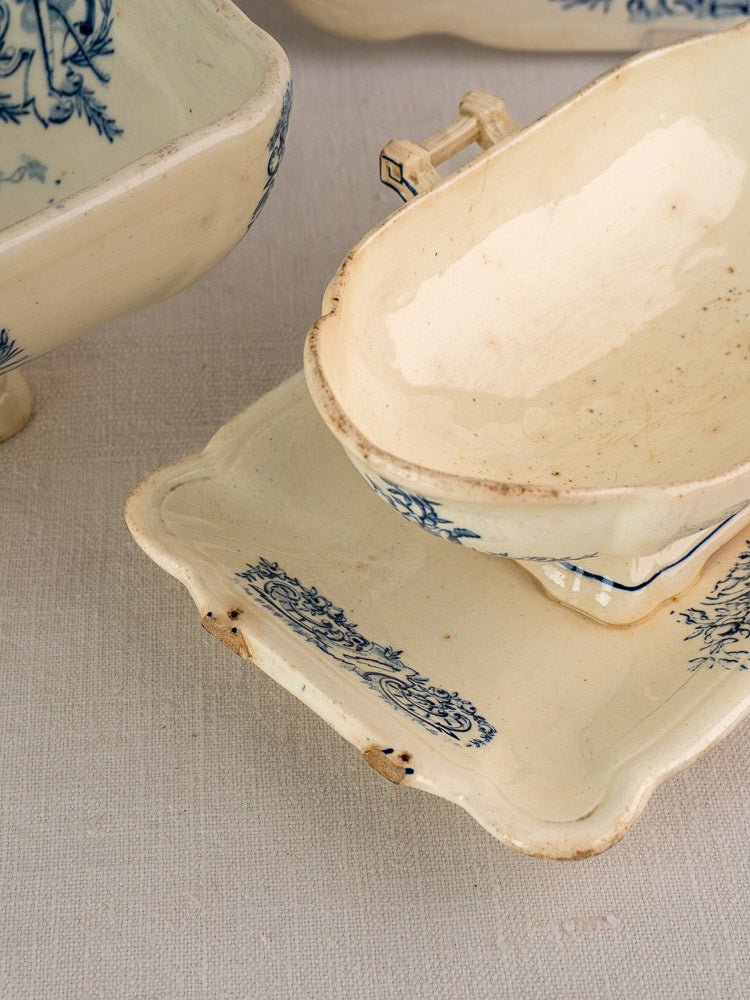 Antique French Clairefontaine faience service, 40 pieces in cream ceramic with blue floral designs on beige surface.